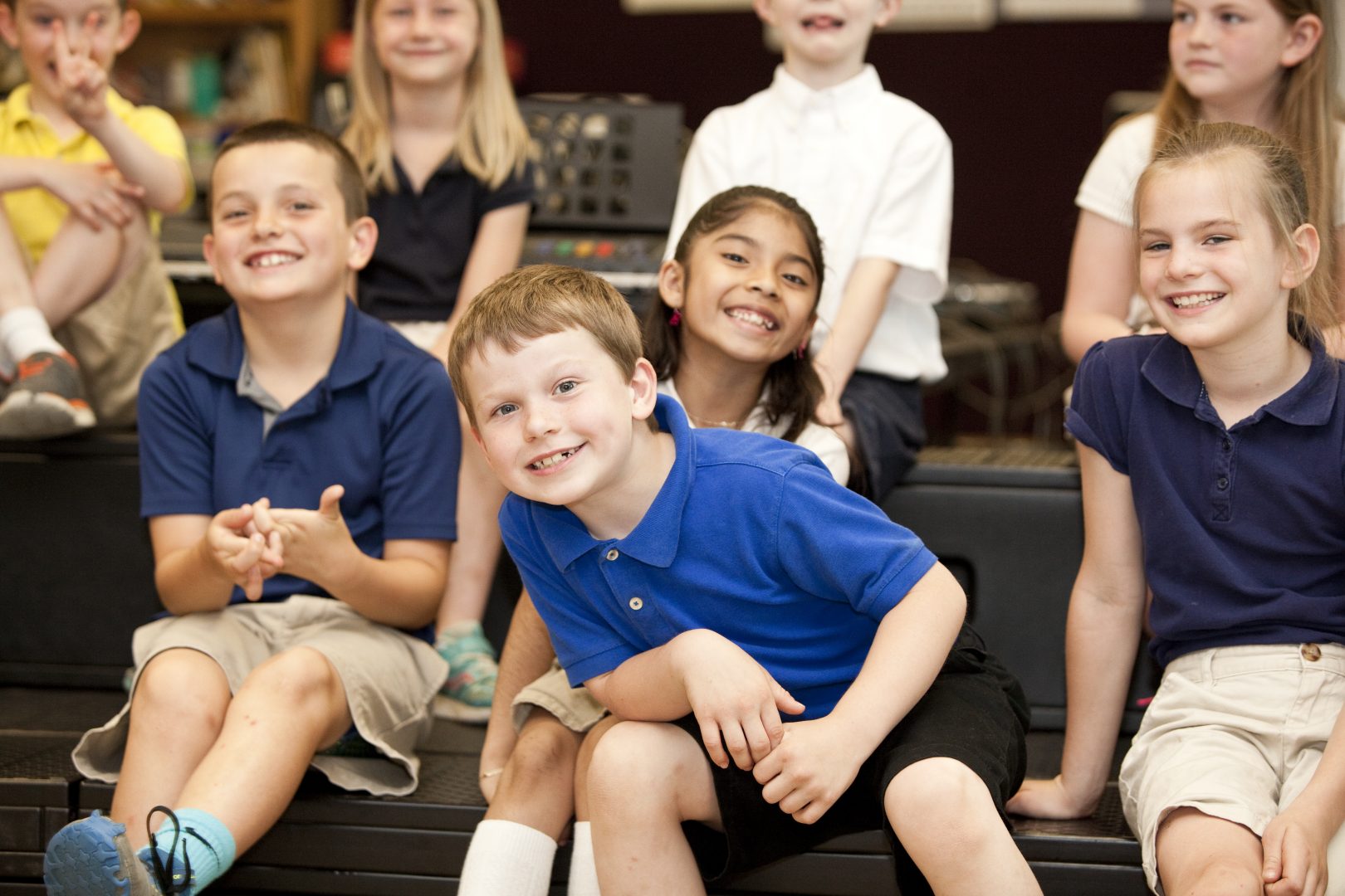 A group of elementary students smile for the camera